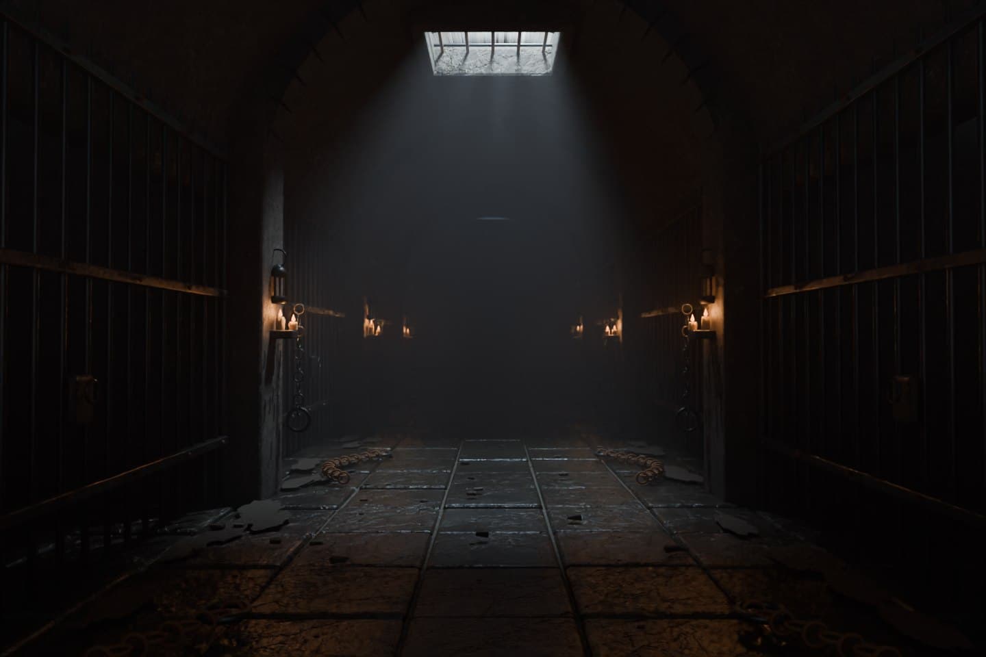 A dark stone dungeon corridor with barred cells, candles and light falling through a ceiling grate